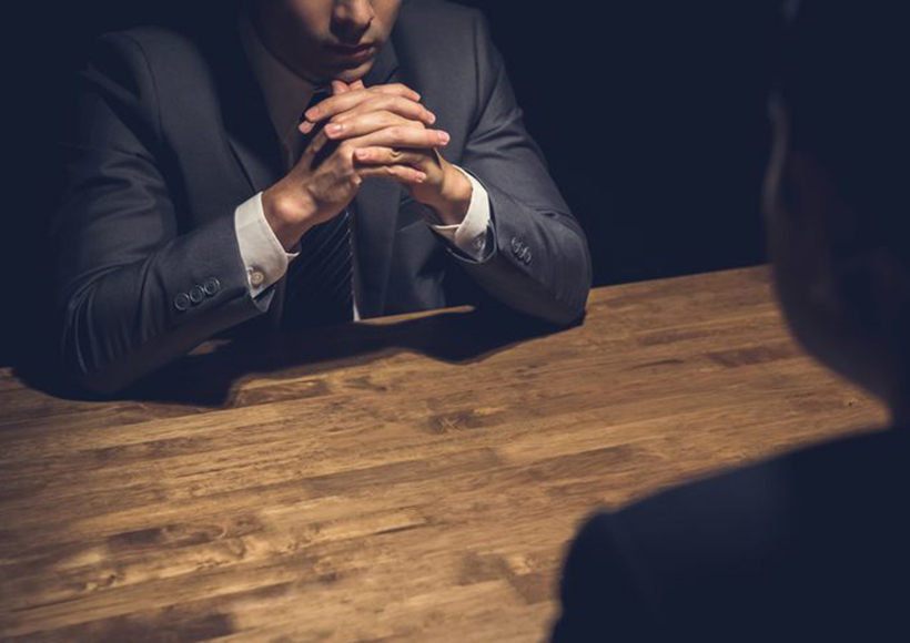 shady-negotiation negotiation across the table in the dark