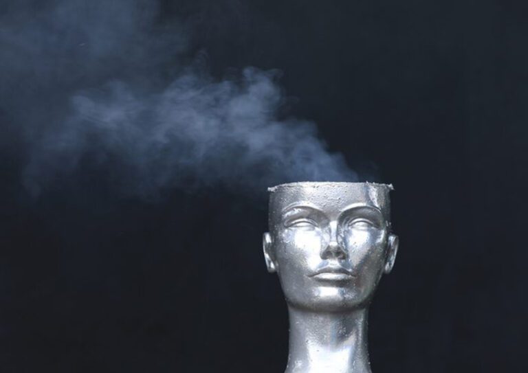 cure-worse-than-disease sculpture without a complete head and smoke coming from the top