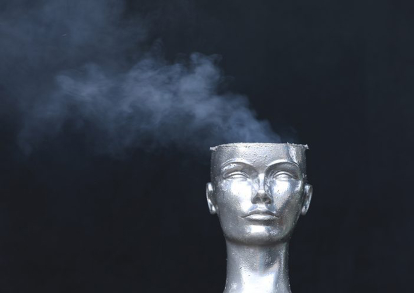 sculpture without a complete head and smoke coming from the top