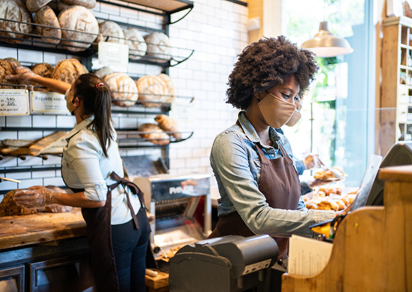 covid-pandemic-workplace employee wearing mask at work in bakery