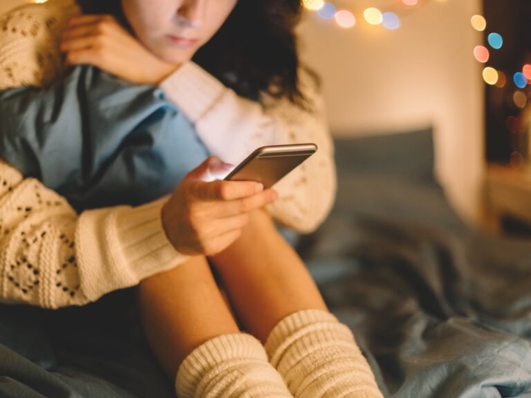 girl-in-bed-using-phone FTC Issues First Major COPPA Rule Update in Over a Decade